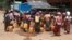FILE - This photo taken on April 29, 2024, shows Kayah people gathering at a delivery of drinking water by the charity Clean Yangon at a camp for internally displaced people in Demoso township, in Myanmar's eastern Kayah state.