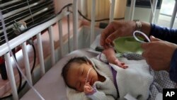 A newborn baby is cared for at the Ataturk Children's Hospital a day after being rescued from a deadly attack on another maternity hospital, in Kabul, Afghanistan, May 13, 2020. 
