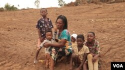 Ama Serwah was growing crops to feed her family, but the land she leased was cleared, leaving her wondering how she will support them, in Asikesu, Ghana. (S. Knott/VOA)