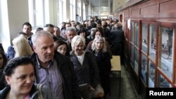 FILE - People wait in line to cast their votes at a polling station during Serbian presidential election in the ethnically divided town of Mitrovica, Kosovo, April 2, 2017. Kosovars go to the polls Sunday to choose a new parliament.