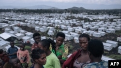 FILE - Women gather on a hill in the Rusayo IDP camp, home to tens of thousands of war-displaced people, on the outskirts of Goma, eastern Democratic Republic of Congo, on October 2, 2023.