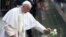 Pope Francis places a white rose at the South Pool of the 9/11 Memorial in downtown Manhattan, Sept. 25, 2015, in New York.