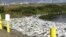 Untreated waste and honey bucket bags at the edge of a sewage lagoon in Toksook Bay in Alaska's Bethel Census Area.