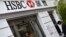 FILE - A worker uses an ATM at a branch of HSBC in Chinatown in central London, June 9, 2015.