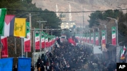 People walk toward the grave of the late Iranian Revolutionary Guard General Qassem Soleimani in the city of Kerman on Jan. 4, 2024, as Iran grapples with its worst mass-casualty attack in decades.