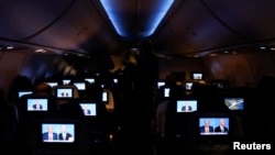 人们在佛罗里达州迈阿密的一架德尔塔航班上观看拜登与特朗普的总统辩论。(2024年6月27日)