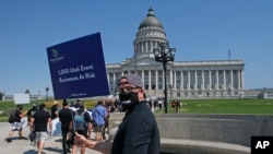 FILE - Special events workers who were forced out of work because of the COVID-19 pandemic marched, July 21, 2020, in Salt Lake City.