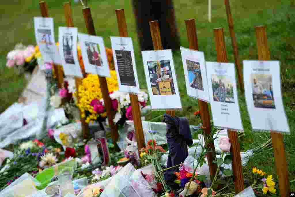 Rain soaked memorials for those who died sit along the roadside by Schemengees Bar &amp; Grille, Oct. 30, 2023, in Lewiston, Maine. The deadliest mass shooting in Maine history propelled homicides to a new high in the state in 2023, hitting at least 50 to shatter the previous record as the end of the year approaches, officials said.