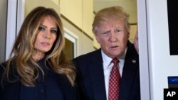 President Donald Trump and first lady Melania Trump talk with reporters on board Air Force One while traveling to Palm Beach, Fla., Feb. 10, 2017. 