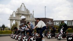 People take part in "Cycle to Save Lives," a 48-hour nonstop static relay cycle challenge, at the Neasden Temple, the largest Hindu temple in the U.K., in north London, to raise money to help coronavirus relief efforts in India, May 1, 2021.