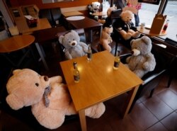 Teddy bears sit at tables in the Bap cafe after it was restricted to takeout sales only amid the outbreak of the coronavirus disease in Altrincham, England, Jan. 27, 2021.