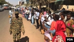 Protesting journalists line up outside the National Council for Press and Publications building in Khartoum, Sudan, Dec. 29, 2016.