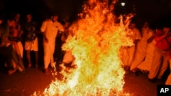 Opposition Congress party activists burn an image of Chief Minister Pinarayi Vijayan in reaction to reports of two women of menstruating age entering the Sabarimala temple, one of the world's largest Hindu pilgrimage sites, in Thiruvananthapuram, Kerala, India.