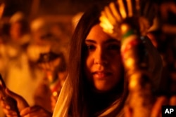 A Zoroastrian youth carries a torch during the Sadeh festival on the outskirts of Tehran, Iran, on Jan. 30, 2024. Hundreds of Zoroastrian minorities gathered after sunset to mark their ancient feast.