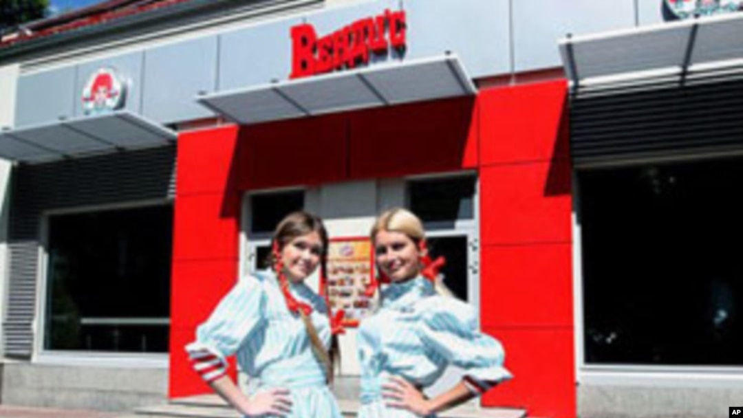 Wendy's Russia workers pose out side of the new restaurant in Moscow, August 2011