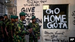 FILE - Sri Lanka army soldiers patrol near the official residence of president Gotabaya Rajapaksa three days after it was stormed by anti-government protesters in Colombo in Colombo, Sri Lanka, July 12, 2022.