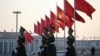 FILE - Chinese People's Liberation Army soldiers patrol at Tiananmen Square in Beijing, March 7, 2024.