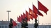 FILE - Chinese People's Liberation Army soldiers patrol at Tiananmen Square in Beijing on March 7, 2024.