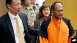 FILE - Jose Ines Garcia Zarate, right, is led into the courtroom by San Francisco Public Defender Jeff Adachi, left, and Assistant District Attorney Diana Garcia, center, for his arraignment in San Francisco, July 7, 2015.