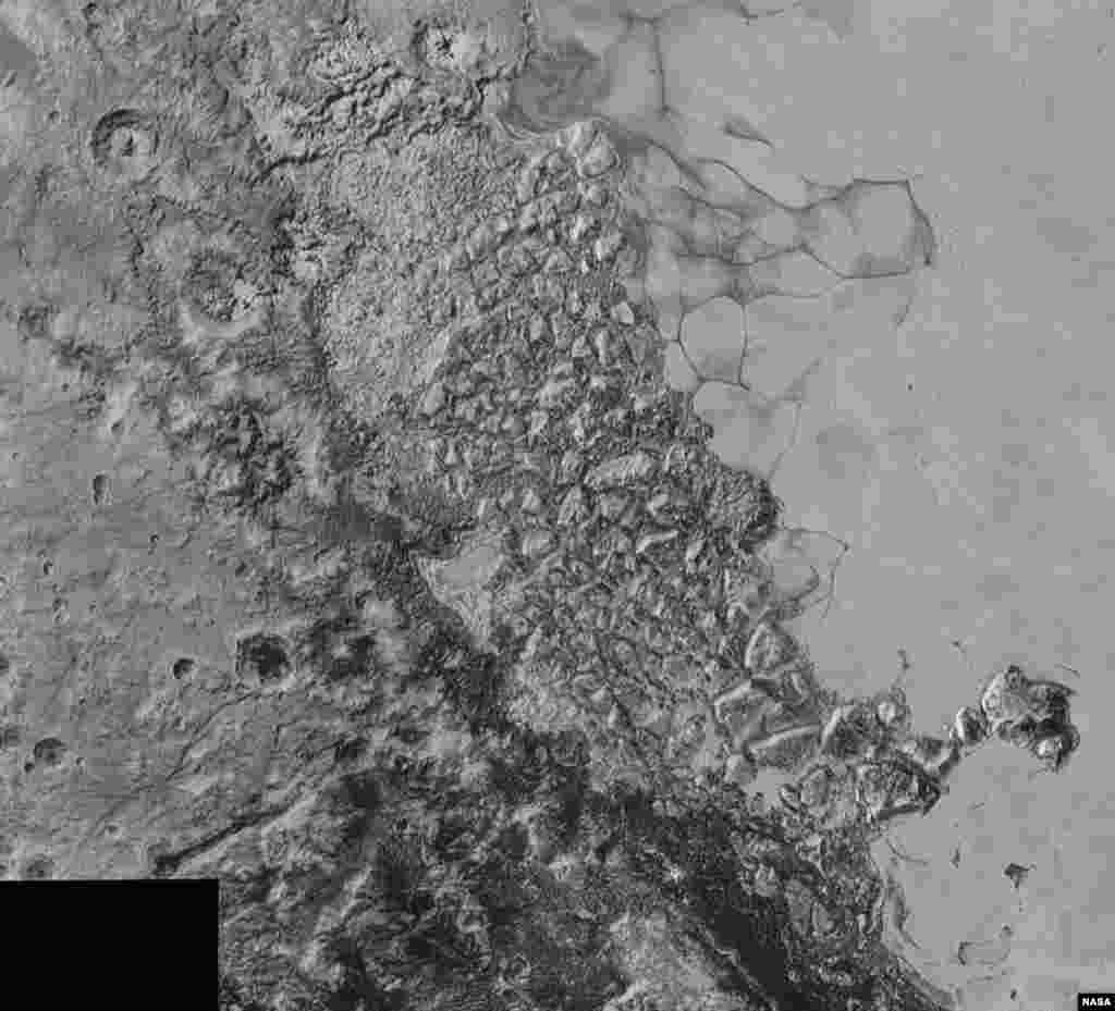 In the center of this 300-mile (470-kilometer) wide image of Pluto from NASA’s New Horizons spacecraft is a large region of jumbled, broken terrain on the northwestern edge of the vast, icy plain informally called Sputnik Planum, to the right. The smallest visible features are 0.5 miles (0.8 kilometers) in size. This image was taken as New Horizons flew past Pluto on July 14, 2015, from a distance of 50,000 miles (80,000 kilometers).