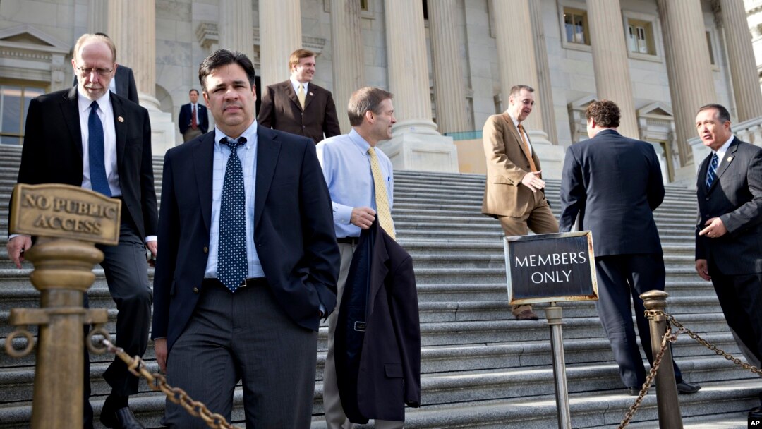 Rep. Raul Labrador (2nd from L) and members of the House of Representatives leave after the Republican-controlled House voted to let insurance companies sell individual health coverage to all comers, even if it falls short of required standards in "Obamac
