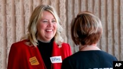 In this Jan. 27, 2018, former Arizona state Sen. Debbie Lesko speaks with a constituent during the meeting of the state committee of the Arizona Republican Party in Phoenix. 