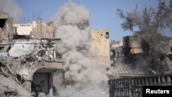 Smoke rises after a landmine exploded as fighters of Syrian Democratic Forces are clearing roads after the liberation of Raqqa, Syria, Oct. 18, 2017. 