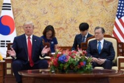 President Donald Trump, left, speaks as he sits with South Korean President Moon Jae-in, right, during a bilateral meeting at the Blue House in Seoul, Sunday, June 30, 2019.