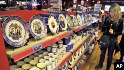 A woman views crockery featuring images of Britain's Prince William and his fiancee Kate Middleton in a souvenir shop in Piccadilly Circus in central London