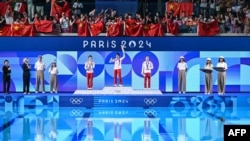 Left to right, silver medallist Chen Yuxi of China, gold medallist Quan Hongchan of China and bronze medallist Kim Mi Rae of North Korea stand on the podium after the women's 10-meter platform diving final during the Olympic Games in Saint-Denis, France, on Aug. 6, 2024.