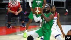 FILE - Nigeria's Ike Nwamu (34) shoots against the United States during an exhibition basketball game in Las Vegas, July 10, 2021.