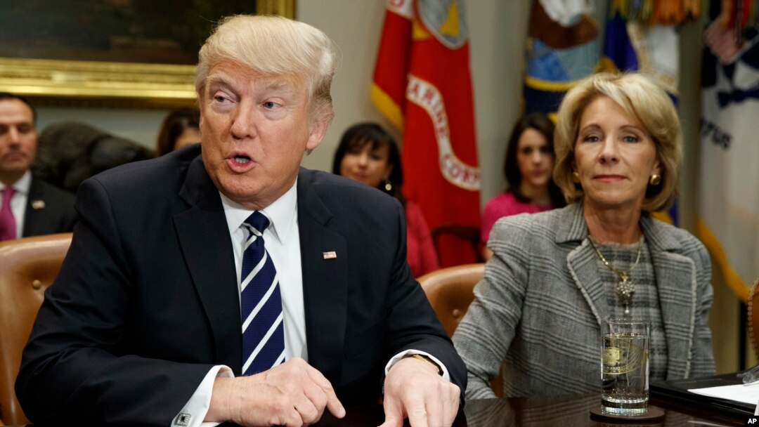 President Donald Trump accompanied by Education Secretary Betsy DeVos, speaks during a meeting with parents and teachers, Feb. 14, 2017, in the Roosevelt Room of the White House in Washington. 