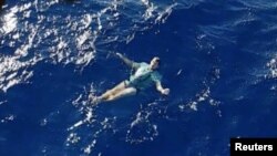 A man who used his jeans as a makeshift flotation device, after being knocked off a yacht and stranded at sea, is rescued by a helicopter, off Tolaga Bay in Gisborne, New Zealand, in this still from a handout video taken March 6, 2019. Handout video taken