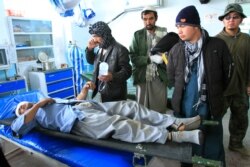 An Afghan man wounded in a roadside blast is treated at a local hospital in the city of Ghazni, west of Kabul, Afghanistan, Dec. 13, 2019.