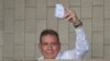 (FILES) Venezuelan opposition presidential candidate Edmundo Gonzalez Urrutia shows his ballot as he votes at the Santo Tomas de Villanueva school in Caracas during the presidential election on July 28, 2024.