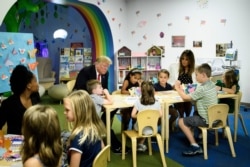FILE - U.S. President Donald Trump and First Lady Melania Trump visit children at Nationwide Children's Hospital in Columbus, Ohio, Aug. 24, 2018. A Chinese American couple has been charged with stealing scientific trade secrets from the hospital.