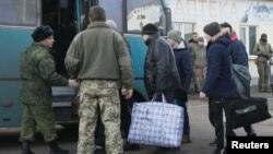 Prisoners of war (POWs) from the separatist self-proclaimed Luhansk People's Republic (LNR) board a bus during the exchange of captives near the city of Bakhmut in Donetsk region, Ukraine, Dec. 27, 2017. 