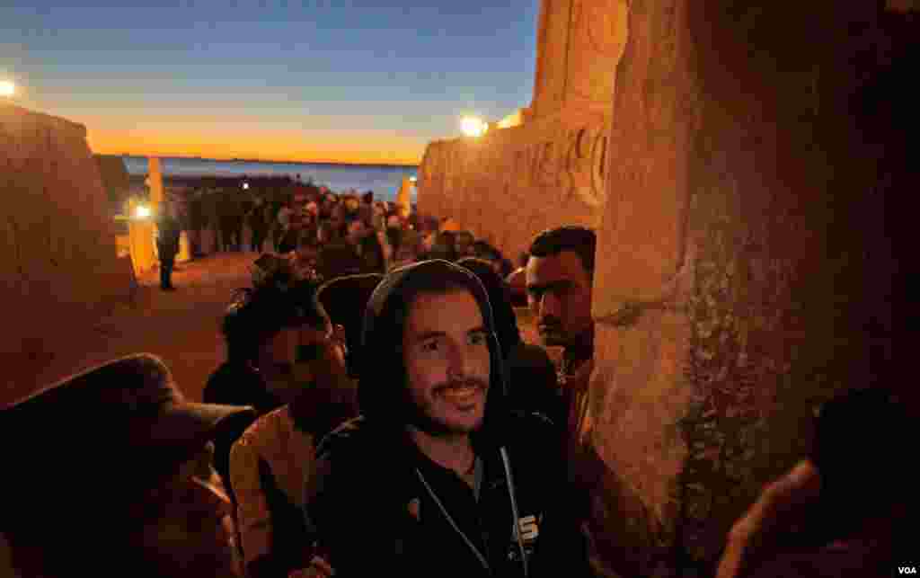  Tourists gather to as the beam from the rising sun hits the innermost sanctuary to illuminate the statues of king Ramses II, his wife Nefertari, and God Amun Re. (Hamada Elrasam/VOA)