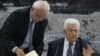 Palestinian president Mahmud Abbas (R) gestures as he signs a request to join 15 United Nations agencies at his headquarters in the West Bank city of Ramallah on April 1, 2014.