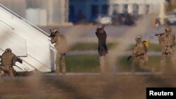 Two hijackers of a Libyan Afriqiyah Airways Airbus A320 surrender to Maltese military on the runway at Malta Airport, Dec. 23, 2016. 