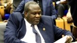 South Sudan's opposition leader Riek Machar reads documents in Khartoum, Aug. 30, 2018, as Sudanese and South-Sudanese leaders signed a deal to end their civil war.