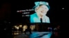 Seorang pria berjalan melewati gambar Ratu Elizabeth II yang diproyeksikan ke layar besar di kawasan Piccadilly Circus di London, Kamis, 8 September 2022.