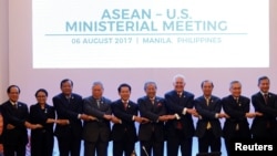 FILE - U.S. State Secretary Rex Tillerson (4th-R) link arms with ASEAN foreign ministers and their representatives as they take part in the ASEAN-U.S. Ministerial meeting during the 50th Association of Southeast Asia Nations (ASEAN) Regional Forum (ARF) in Manila, Philippines August 6, 2017.