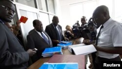 Gay and human rights activists (L) file a constitutional petition against a new anti-homosexuality law, at the courts in Uganda's capital Kampala, March 11, 2014.