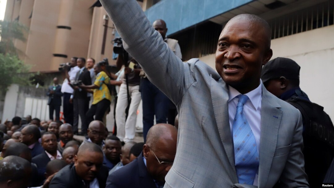 FILE - Former Congolese Interior Minister Emmanuel Ramazani Shadary waves to his supporters as he arrives to file his candidacy for the presidential election, at the Congo's electoral commission head offices at the Gombe Municipality in Kinshasa, Democratic Republic of the Congo, Aug. 8, 2018. 