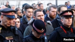 Police officers attend a vigil for victims of a fatal attack on London Bridge in London, Britain, Dec. 2, 2019.