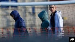 Migrant teens walk inside the Tornillo detention camp in Tornillo, Texas, Thursday, Dec. 13, 2018.