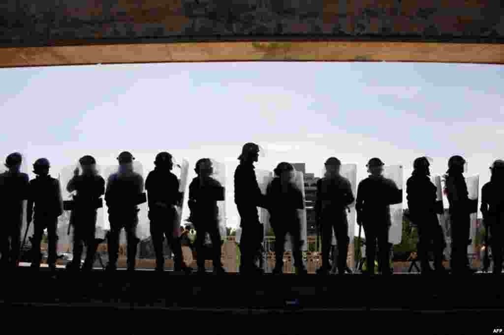 March 18: Riot police stand guard during a demonstration in Tahrir Square in central Baghdad, Iraq. (AP/Khalid Mohammed)