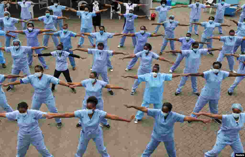 Nurses participate in a Zumba aerobic fitness program as a way of helping them to cope with working situations during the coronavirus outbreak within the Infectious Disease Unit grounds of the Kenyatta National Hospital in Nairobi, Kenya.