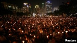 FILE - Candles flicker in Hong Kong's Victoria Park during a June 4, 2009, vigil to remember the crackdown on the pro-democracy movement in Beijing's Tiananmen Square. 